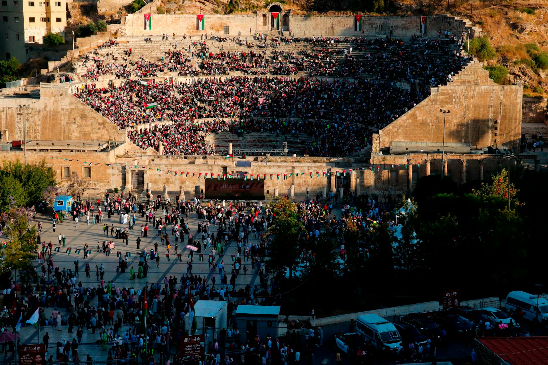 Crowds enjoying cultural performances and local cuisine during a festival in Jordan.